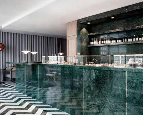 Photo of Maison du Danemark House of Denmark in Paris. Green stone bar top reflecting marble trends.